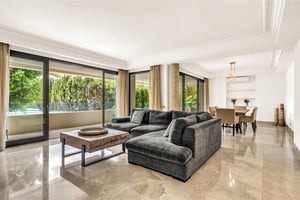 Spacious living room with panoramic windows and garden views in luxury residence