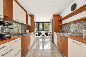 Fully equipped modern kitchen with granite countertops and natural wood finishes
