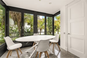Cozy breakfast area surrounded by tropical greenery and natural light in Marbella apartment