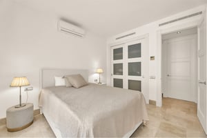 Minimalist bedroom with built-in wardrobe and soft ambient lighting in luxury residence