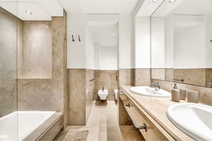 Modern bathroom with double sink, marble finishes, and integrated bidet in Los Monteros Park