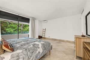 Master suite with floor-to-ceiling windows and garden-facing balcony in Los Monteros Park
