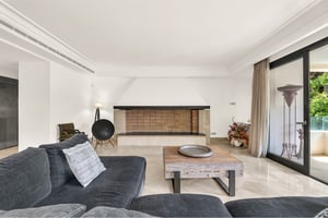 Elegant hallway with marble floors and recessed lighting in Los Monteros Park apartment